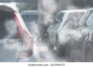 Air pollution from car exhaust smoke traffic in the city. Reducing global warming pollution and carbon dioxide from engine combustion.