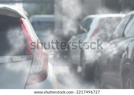 Air pollution from car exhaust smoke traffic in the city. Reducing global warming pollution and carbon dioxide from engine combustion.