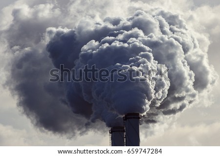 Air pollution from power plant chimneys.