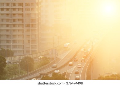 Air pollution scenic with cars on highway and yellow smoke in city.