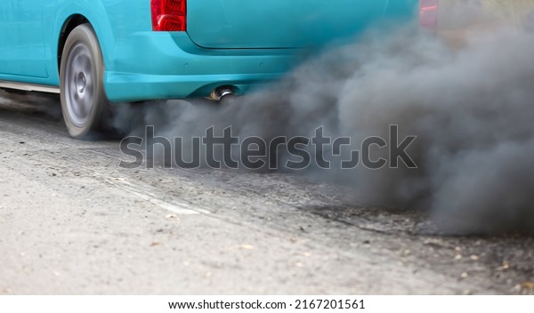 Air pollution\
from vehicle exhaust pipe on\
road