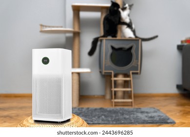 air purifier in the area with pets or cat. Air Pollution Concept. Air purifier, filters out invisible viruses, allergens or pollutants in the house on a cat tree background. Cute cat and Air purifier