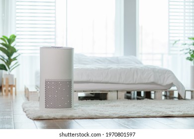 Air purifier in cozy white bedroom for filter and cleaning removing dust PM2.5 HEPA in home,for fresh air and healthy life,Air Pollution Concept - Shutterstock ID 1970801597