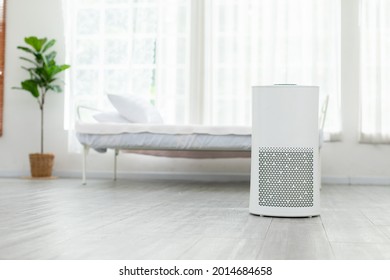 Air purifier in cozy white bedroom for filter and cleaning removing dust PM2.5 HEPA and virus in home,for fresh air and healthy Wellness life,Air Pollution Concept - Shutterstock ID 2014684658
