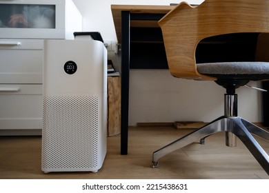 air purifier in the interior of the room next to the workplace, air purifier from fine dust in the house. protect the concept of PM 2.5 dust and air pollution - Shutterstock ID 2215438631