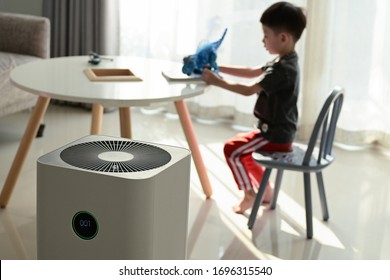 air purifier in living room with kid playing inside home
