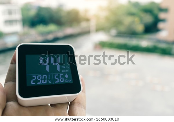 air quality\
monitoring device at building\
balcony
