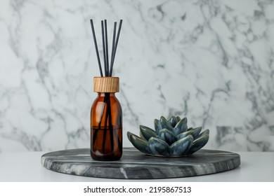 Air Reed Freshener And Ceramic Decor On Table Near Marble Wall. Space For Text