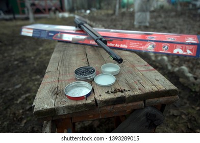 Air Rifle, Box And Bullets On The Bench