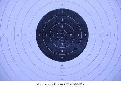 An Air Rifle Shooting Target With A Close-up.A Black And White Target.