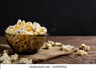 Air salty popcorn.A bowl of popcorn on a wooden table.Salt popcorn on the wooden background . 
With space for text.Top view.popcorn texture.Chees .
