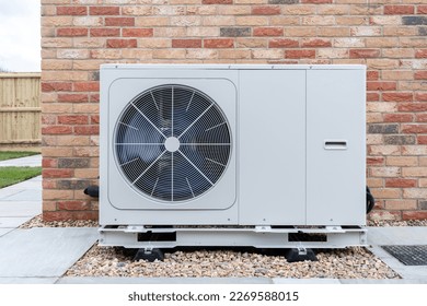 Air Source heat pump fitted outside a new home development - Shutterstock ID 2269588015