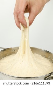 Air Sourdough With Bubbles. The Hand Pulls The Yeast Dough.