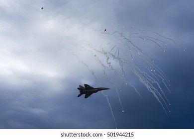 Air Strike. Fighter Jet In Dogfight. Aircraft In Battle Firing Defense Flares. War Zone.