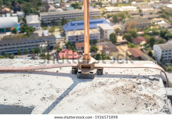 Air terminal\
rod and bare copper cable install on rooftop of high building for\
Lightning protection and protect electrical equipment damage when\
raining and lightning\
strike.