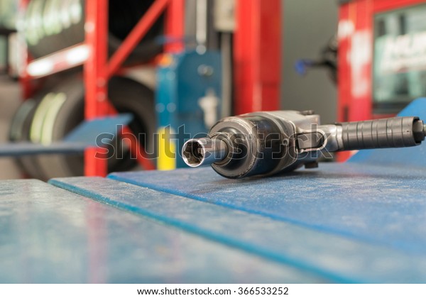 Air tools at car garage for checking a car brake\
system and wheel and tire.