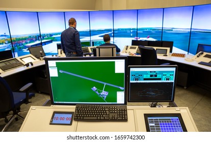 Air Traffic Control Simulator Station. Green Monitor Screen In The Foreground. Trainer In The Background.