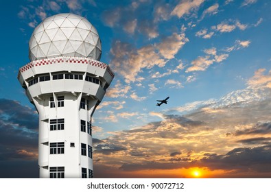 Air Traffic Control Tower  With Airplane Silhouette Over Sunset