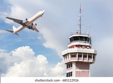 Air Traffic Control Tower In International Airport With White Passenger Airplane Jet Taking Off On Sky