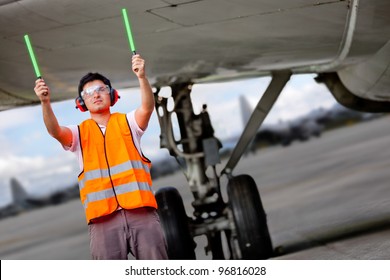 Air Traffic Controller Holding Light Signs At The Airport