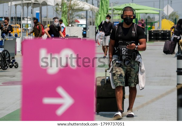 Air travelers\
arrive in the ride share lot while Uber and Lyft drivers take part\
a rally calling for basic employment rights at LAX on Thursday,\
Aug. 20, 2020 in Los Angeles.\
