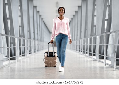 Air Travels. Portrait Of Happy African American Woman Walking In Airport Terminal With Suitcase, Full Length Shot Of Cheerful Black Lady Travelling Abroad For Summer Vacation Or Having Business Trip