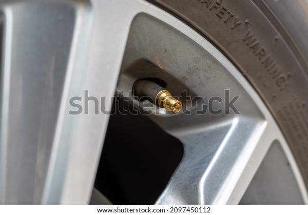Air valve of a car tire\
close-up.