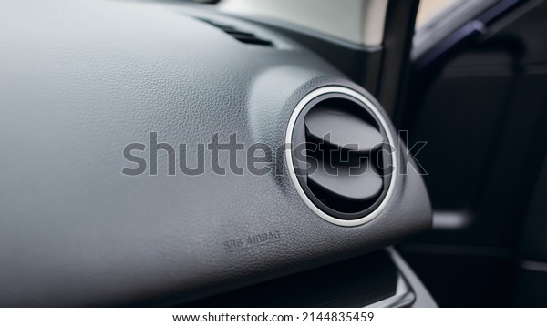 Air vent grill and air conditioning in modern\
car interior.