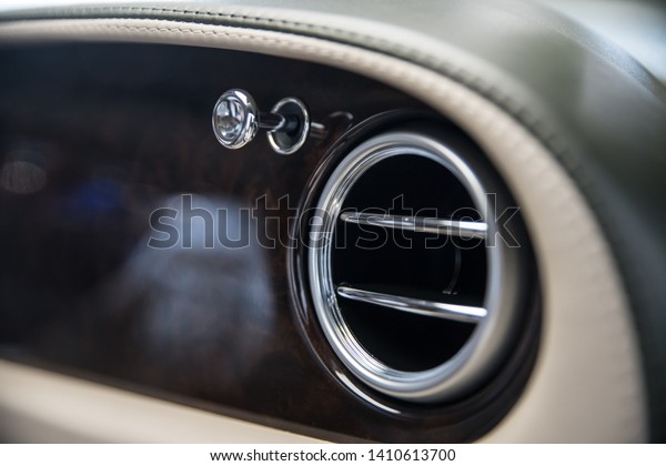 Air vents in luxury car. Air\
ventilation and conditioning in car. Modern car\
interior