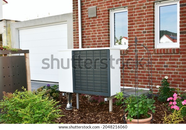 Air-Air Heat Pump for Heating and\
hot Water in Front of an new built Residential\
Building
