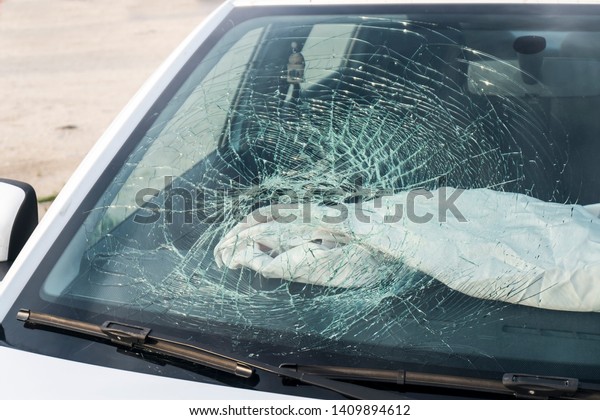 Airbag.\
Broken car window, an accident on the road.\
