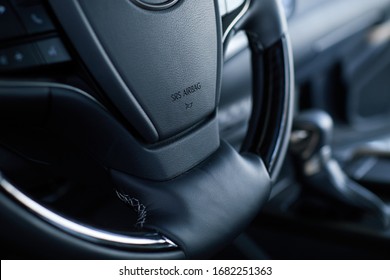 Airbag icon on steering wheel of car close up. The concept of selling a new car in showroom