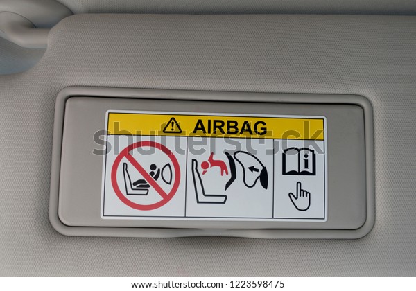 Airbag warning sign at sun\
visor 