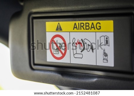 Airbag warning sticker on a new vehicle sun shade