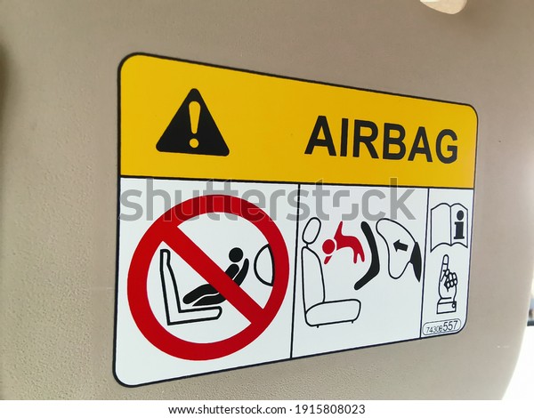 An airbag warnings\
sticker on a car