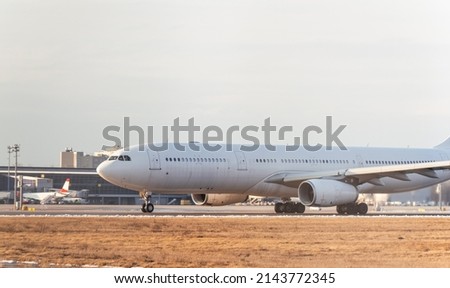 Airbus A330 taking off from the international airport. Cargo white aircraft without airline's livery and logo on the runway
