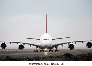 Airbus A380 jet airliner on runway - front view