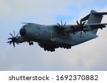 Airbus A400 Atlas military transport plane flying low with wheels down