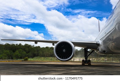 Aircraft (airplane) running jet engine after maintenance. Jet engine blowing dust in the wind while engine running.