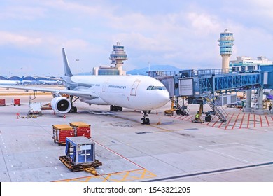  Aircraft with airport ground equipment. Preparation of the airplane before flight.  View of the airport apron and control towers. Hong Kong. China