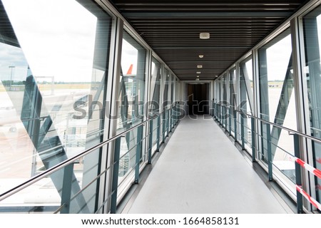 Aircraft boarding bridge terminal gate tunnel passage at an international airport. Travel concept