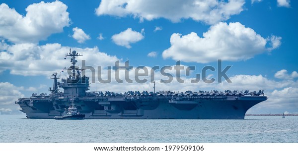 Aircraft carrier crossing the\
ocean, US Navy Nuclear Aircraft carrier, Warship, Naval Forces\
Military control of the sea. Protection of state borders from\
water.