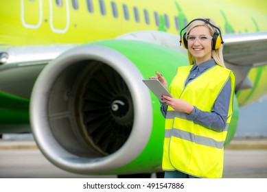 Aircraft Engineer With A Checklist In His Tablet