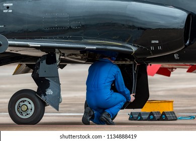 Aircraft Engineer Working In The Undercarriage Bay Of A Military Jet Trainer. 