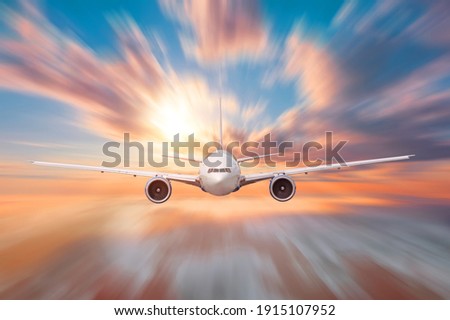 Aircraft flies motion effect high in the sky over the clouds dawn, traveling in the celestial expanse