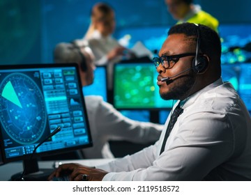 Aircraft Flight Control Officer Monitors The Approach Of Aircraft From Control Tower. Air Services Office Is Equipped With Navigation Systems, Radars And Computer Stations. Aviation Concept.