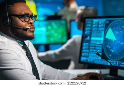 Aircraft Flight Control Officer Monitors The Approach Of Aircraft From Control Tower. Air Services Office Is Equipped With Navigation Systems, Radars And Computer Stations. Aviation Concept.