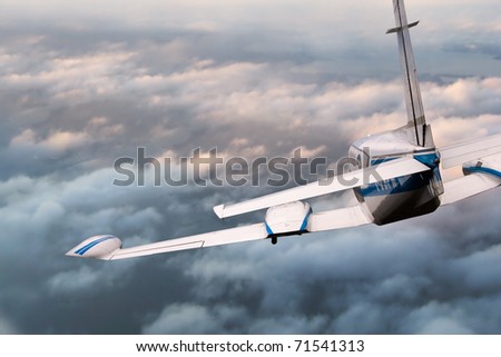 Aircraft in flight descending from above  the clouds