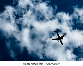 The aircraft flying on the cloudy sky background - Shutterstock ID 2207990199