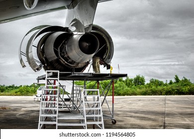 Aircraft Inspector Standing At The Engine For Maintenance Service Check And Repair If Required.Aircraft Inspector Inspection Combustion,turbine Blade Of Jet Engine By Borescope Camera With Tripod . 